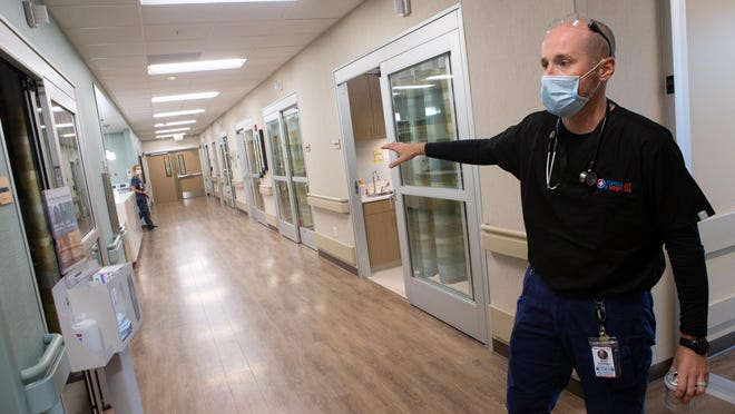 Jared Schreiner, chief medical officer and emergency medicine physician at Topeka ER & Hospital, gestures toward a hallway of emergency rooms at the new micro-hospital. Topeka ER & Hospital, 6135 S.W. 17th St., is the first independently owned micro-hospital in Kansas, Schreiner said.