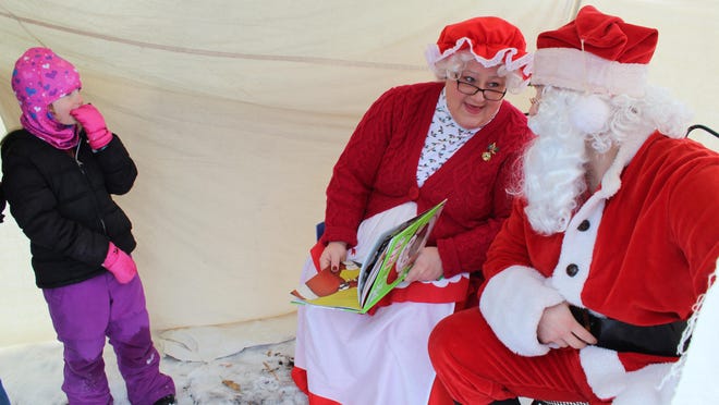 Santa and Mrs. Claus made a special stop in Cheboygan last year, to read books to children on the Children's Trail near Major City Park. Mrs. Claus read books to the children and the duo asked the children what they wanted for Christmas. This year, they will be making an appearance on Dec. 12, but will be practicing social distancing. Tribune File Photo by Kortny Hahn