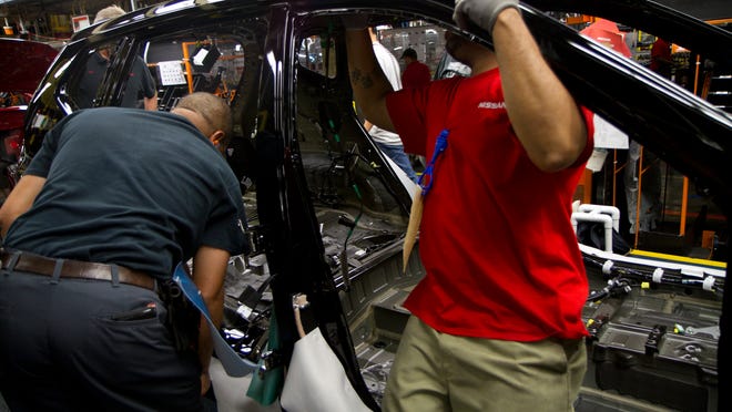
Nissan employees work on a 2014 Rogue at the Smyrna vehicle assembly plant. The compact SUV has been ranked a favorite of compact SUV drivers.
