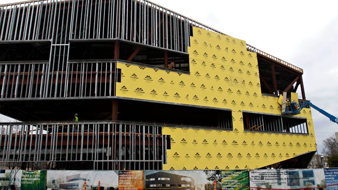 Construction workers put sheathing on MSU’s O'Reilly Clinical Health Science Center on Monday. The building is expected to be complete in July.