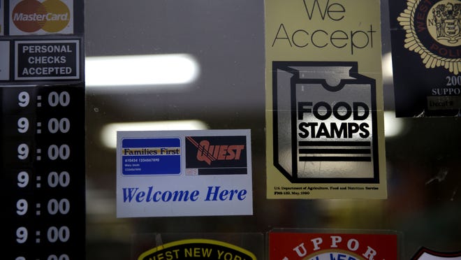 A supermarket in North Jersey. displays stickers indicating it accepts food stamps.