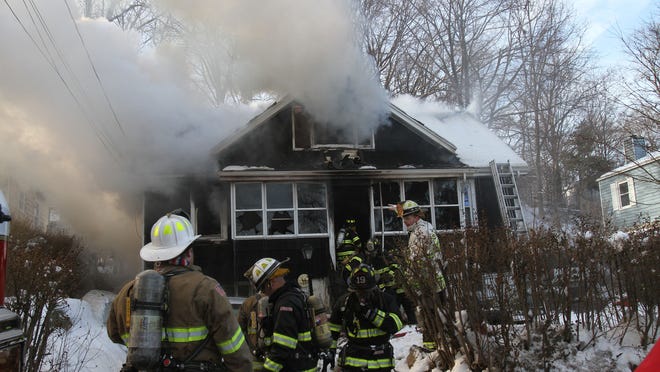 Mahopac Falls firefighters work at the scene of a house fire at 72 Entrance Way in Mahopac Falls Jan. 25, 2015. Firefighters from Mahopac, Mohegan Lake, and Putnam Valley assisted at the scene.