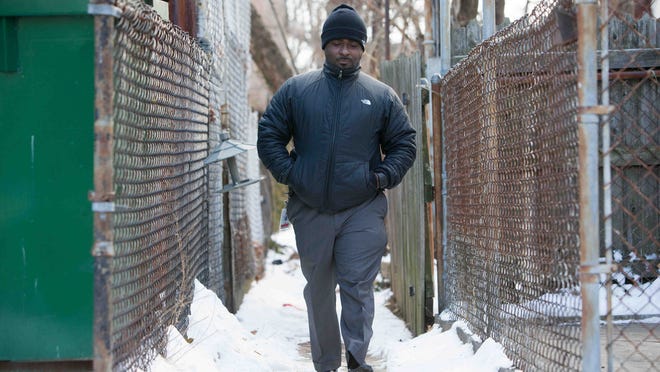 H.B. du Pont Middle School Assistant Principal Terrance D. Newton walks down the Wilmington alley near where he was shot as a teen. His friend, Jamar Kilgoe, was killed Monday at the Rose Hill Community Center. “We’re losing people to the streets,” Newton says.