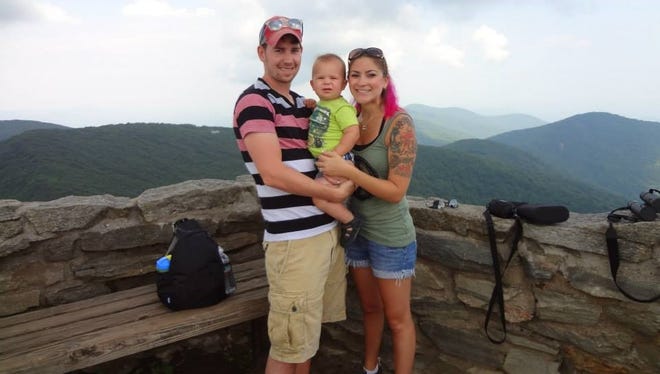 Jake and Jamie Schmalenberger with son, Jude, take in the scenery at Craggy Gardens, a hike off of the Blue Ridge Parkway in North Carolina.