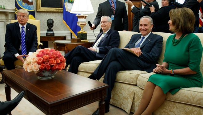 President Donald Trump pauses during a meeting with, from left, Senate Majority Leader Mitch McConnell, R-Ky., Senate Minority Leader Chuck Schumer, D-N.Y., House Minority Leader Nancy Pelosi, D-Calif., and other Congressional leaders in the Oval Office of the White House, Wednesday, Sept. 6, 2017, in Washington. Trump overruled congressional Republicans and his own treasury secretary Wednesday and cut a deal with Democrats to fund the government and raise the federal borrowing limit for three months, all part of an agreement to speed money to Harvey relief.