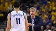 Steve Kerr talks with Klay Thompson during the first