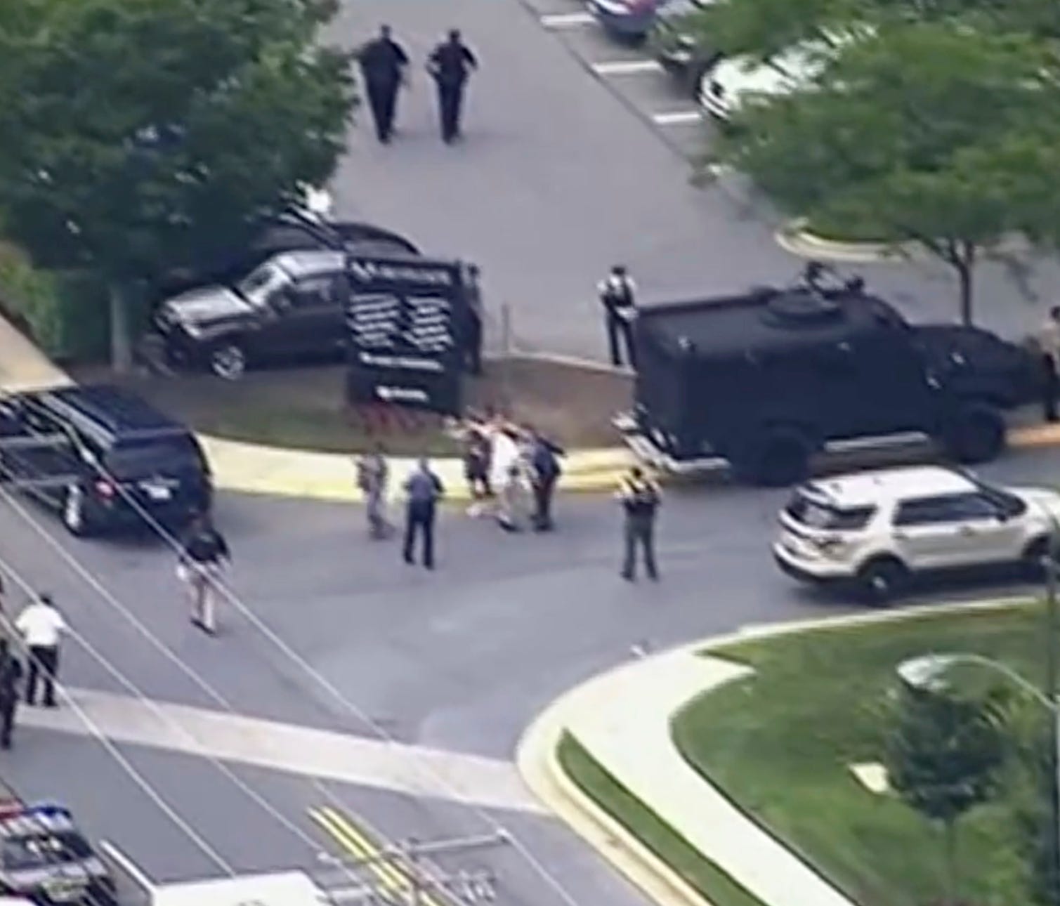 In this frame from video, people leave the Capital Gazette newspaper after multiple people have been shot on June 28, 2018, in Annapolis, Md.