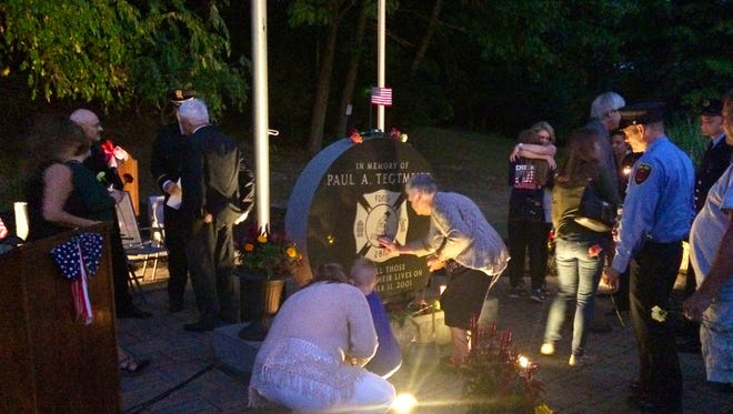 At a candlelight vigil Sunday at Hyde Park's Hackett Hill Park, attendees paid respects to Paul Tegtmeier, a Hyde Park man and firefighter who died on Sept. 11, 2001.