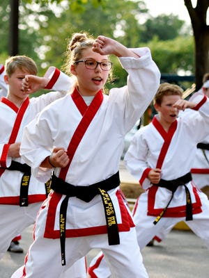 From left, Hunter King, 12, of York Township, Maya Veiss, 12, of Spring Garden Township, and Chase Ford, 14, of Red Lion perform with Kim's Karate Demo Team during the St. Joseph's  Church 26th Annual Carnival in Springettsbury Township, Tuesday, June 13, 2017. The carnival offers food, games rides and music with free admission through Saturday daily from 5-10pm. Dawn J. Sagert photo