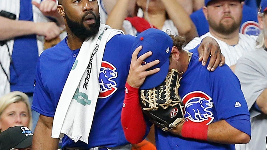 Albert Almora of the Chicago Cubs is comforted by Jason Heyward after checking on a young child who was injured by a hard foul ball off his bat.