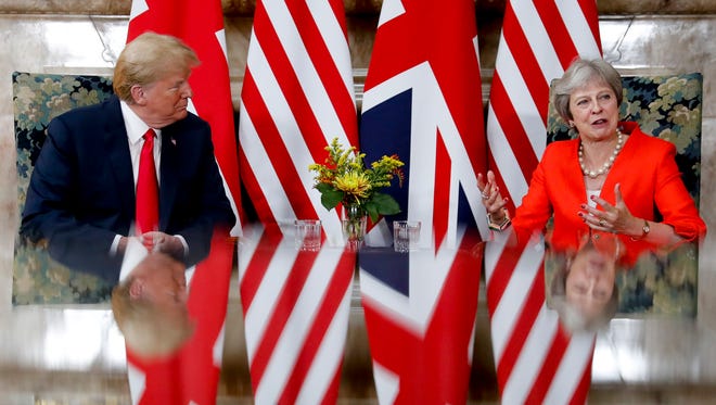 U.S. President Donald Trump talks with British Prime Minister Theresa May, during their meeting at Chequers in Buckinghamshire, England, Friday, July 13, 2018.