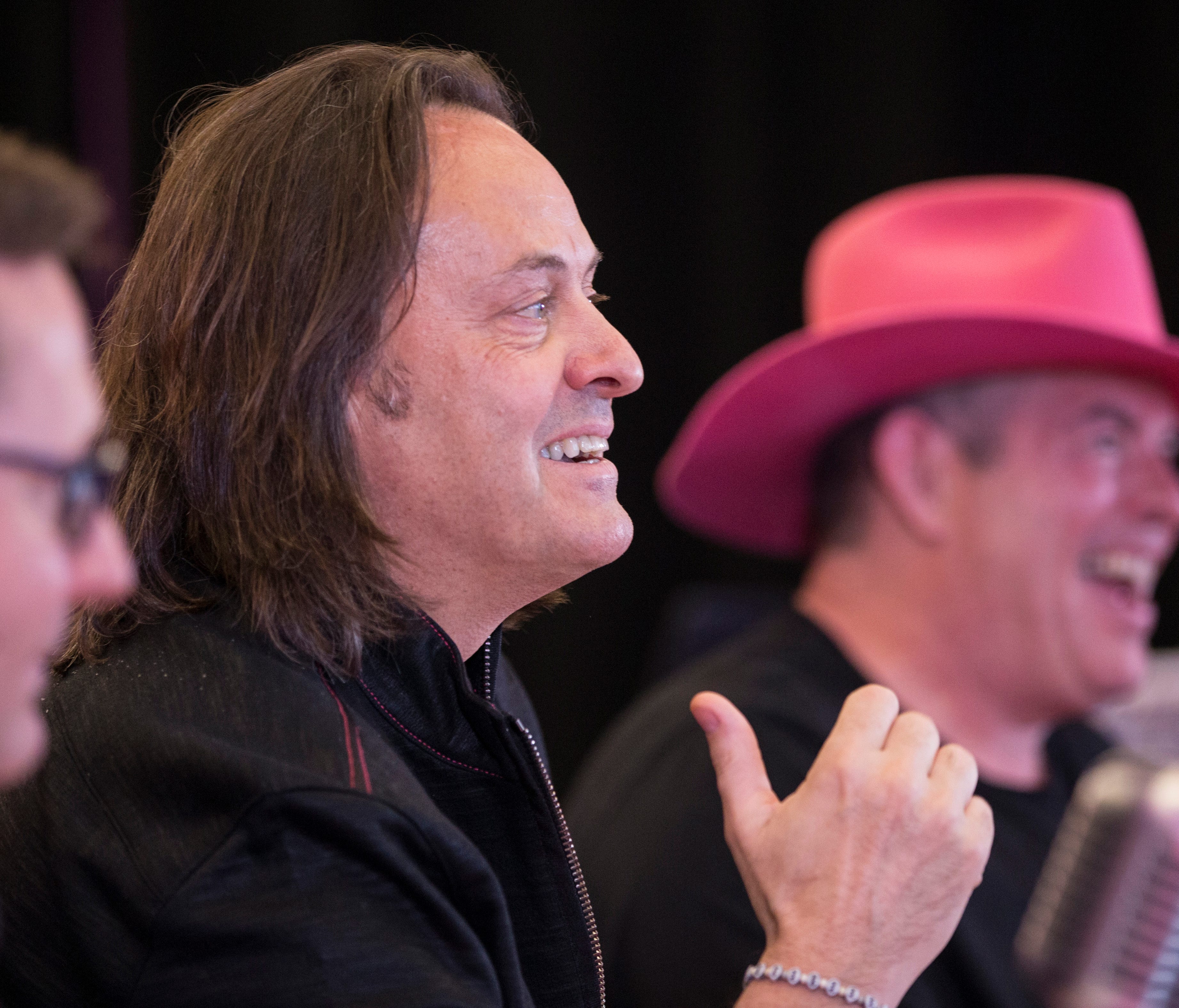 T-Mobile President and CEO John Legere, center, along with T-Mobile Chief Operating Officer Mike Sievert, left, and T-Mobile CFO Braxton Carter, right.