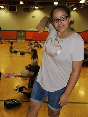 Lanise Harden, a rising sixth-grader who attended the Junior Deputy Camp, demonstrates her favorite radKIDS technique, the elbow strike.