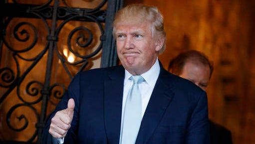 President-elect Donald Trump gives a thumbs up to reporters at Mar-a-Lago, Wednesday, Dec. 28, 2016, in Palm Beach, Fla.