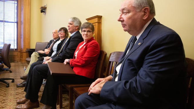 Sen. Jim Denning, right, and Gov. Laura Kelly, second from right, got into tense moments during the State Finance Council meeting on Friday.
