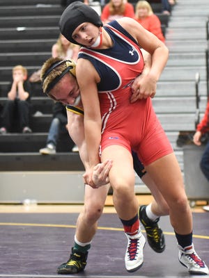 Rachel Watters, right, was the first female middleweight wrestler to win a sectional title in Iowa.