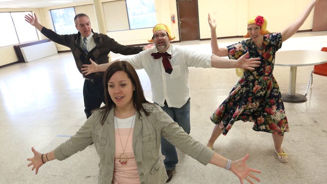 Heart-A-Rama choreographer Lisa Hagenow, front, helps cast members Jim Pautz, Brad Zimmermann and Laurie Maggae with their dance moves during a rehearsal at Meadow Lanes North bowling alley on April 12.