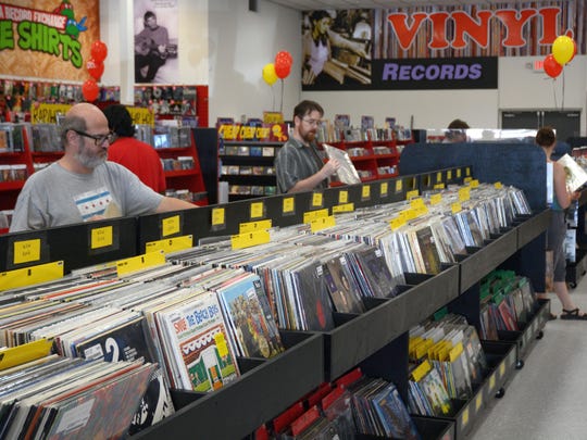 Customers shopping for vinyl at grand opening of Zia megastore in Chandler.