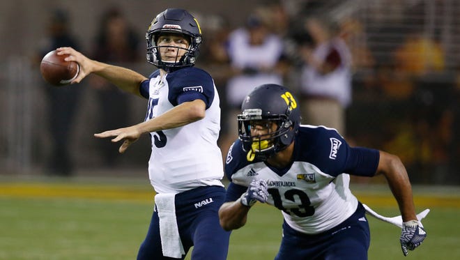 Northern Arizona's Case Cookus, left, looked to pass the football as Kendyl Taylor (13) runs his route against Arizona State during the first half of an NCAA college football game Saturday, Sept. 3, 2016, in Tempe.