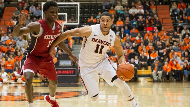 Oregon State guard Malcolm Duvivier (11) dribbles while defended by Stanford guard Marcus Allen (15) at Gill Coliseum on Jan. 6, 2016.