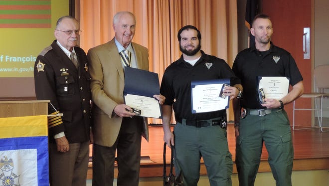 From left are Kenton County Sheriff Chuck Korzenborn; Kent Marcum, Simon Kenton chapter president of the Sons of the American Revolution; Santo, Heroism Award winner; Detective Miguel Rodriguez and Lt. Bart Beck, who received Law Enforcement Commendation Medals from SAR.