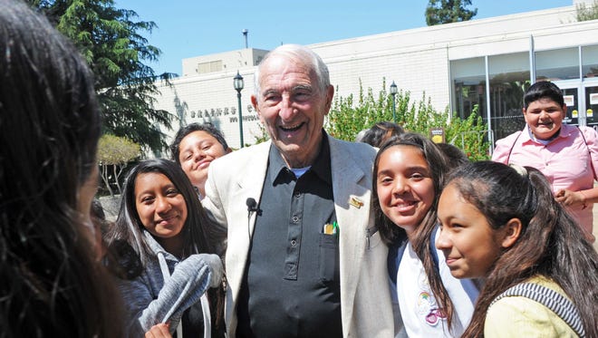 Holocaust survivor Harold Gordon, 87, is surrounded by King City sixth-graders on Tuesday in front of the Rotunda in Salinas. 