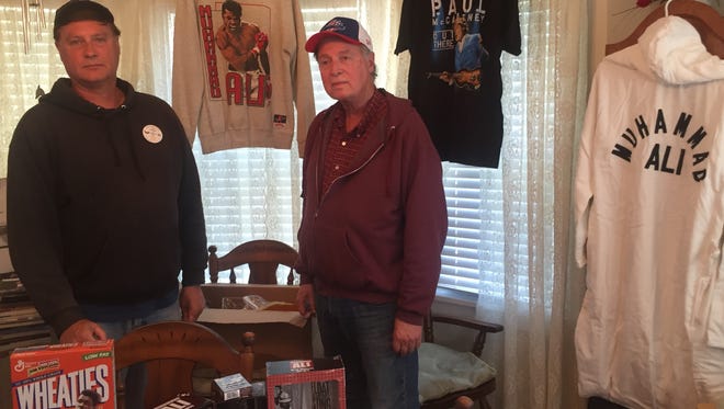 Dan and Jim Cassidy with part of Dan's Ali memorabilia collection, including limited-edition robe. Having met the champ on numerous occasions, the brothers called Ali one of the most influential people in their lives.