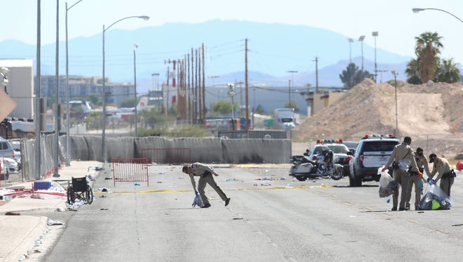 Police gather the personal effects of people who fled and ran across Giles St. near the site of the Las Vegas shooting, October 2, 2017.