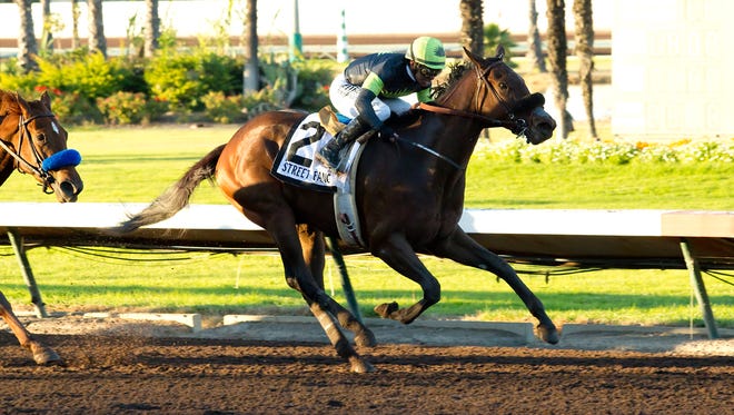 Agave Racing Stable's Street Fancy and jockey Mike Smith win the Grade I, $300,000 Starlet, Saturday, Dec. 12, 2015 at Los Alamitos Race Course.