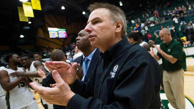 CSU men's basketball coach Larry Eustachy claps with his team while singing the fight song after a Feb. 23 win over New Mexico.