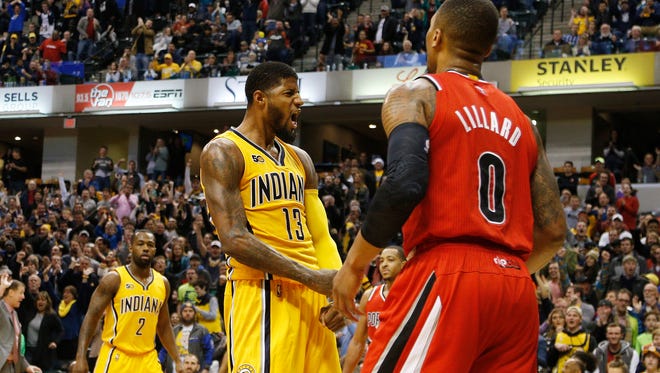 Pacers forward Paul George (13) celebrates in front of Portland Trailblazers guard Damian Lillard (0) after a dunk in the fourth quarter to defeat the Pacers at Bankers Life Fieldhouse.