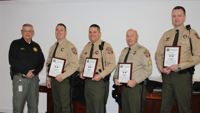 Rutherford County Sheriff Mike Fitzhugh presents Life Saving Awards to from left, Deputy Stephen Massey, Deputy Michael Moody, Sgt. James Davis and School Resource Officer Casey McClure. Not pictured is SRO Mark Meshotto.