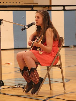 Riley Hader strums her guitar as she prepares for Cascade of Talent a few years ago. White Sulphur Springs students decided to start a statewide talent show after the Great Falls show was canceled.