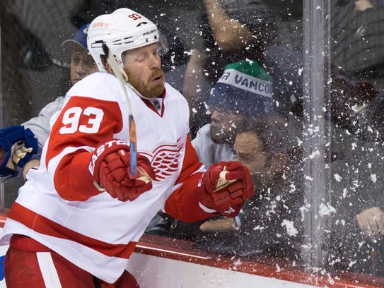 The Detroit Red Wings' Johan Franzen is checked into