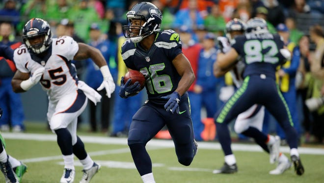 Seattle Seahawks' Tyler Lockett returns a kickoff 103 yards for a touchdown against the Denver Broncos during the first half of a preseason NFL football game, Friday, Aug. 14, 2015, in Seattle.