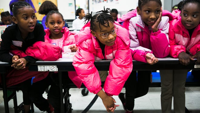 (From left to right) Third grade students Jaylyn Garrison, 9; Bailee Washington, 8; JaKaya Johnson, 8; Myesha Hayes, 8; and Tamya Wilburn, 8, listen to Kaitlyn Schubert (not pictured), a FedEx employee, speak to them during a coat drive at Newberry Elementary School on Thursday.