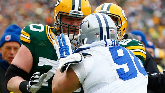 Packers right guard T.J. Lang confronts Cowboys defensive tackle Tyrone Crawford during last week’s NFC divisional playoff game at Lambeau Field. Packers center Corey Linsley said Lang is “the type of guy who’s always going to have your back.”