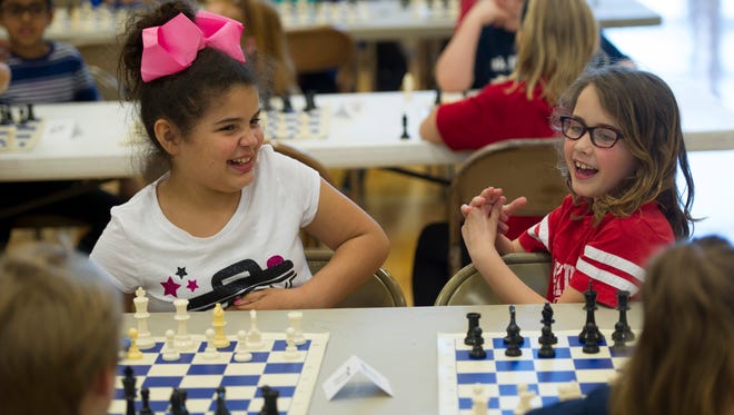 Tracie Mae Skelton, 9, Joshua Academy, left, and Lydia Gossett, 7, Oak Hill, get acquainted before their matches begin at the North Junior High School Spring Scholastic Chess Tournament Saturday afternoon.