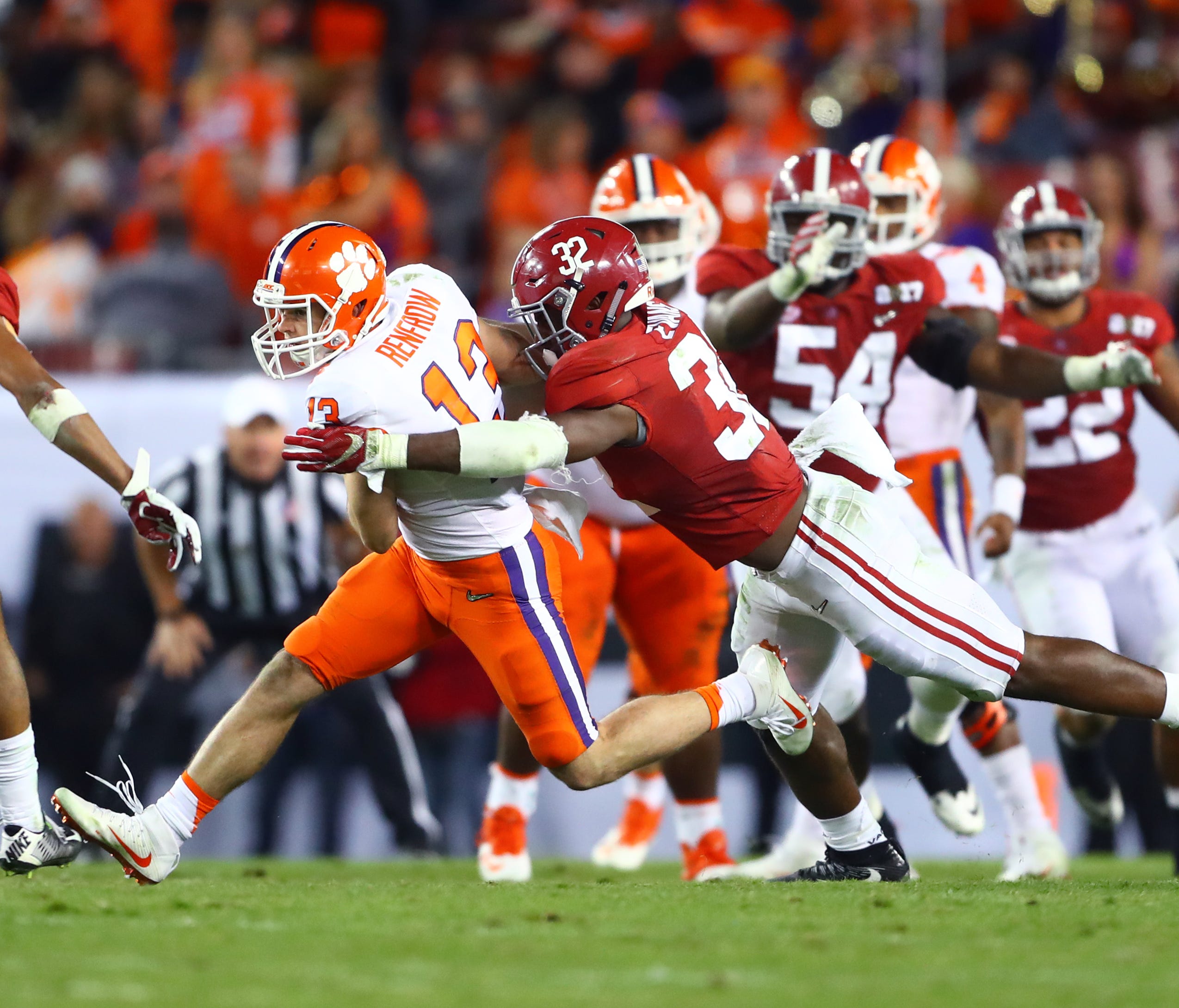 Clemson wide receiver Hunter Renfrow is tackled by Alabama linebacker Rashaan Evans during the College Football Playoff championship game.