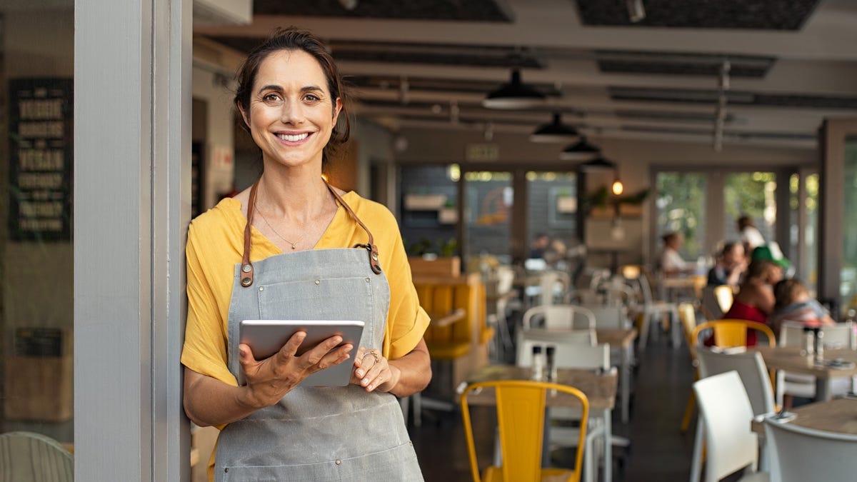 Restaurant worker holding a tablet computer.