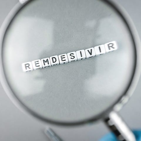 A magnifying glass over cubes spelling out Remdesi