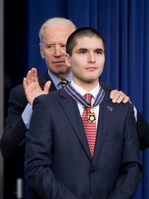 Vice President Joe Biden awards John Michael Capano, son of ATF special agent John Francis Capano, the Medal of Valor during a ceremony in the Old Executive Office Building on the White House Complex in Washington, Wednesday. Medals are award to public safety officers who have exhibited exceptional courage, regardless of personal safety, in the attempt to save or protect others from harm.
