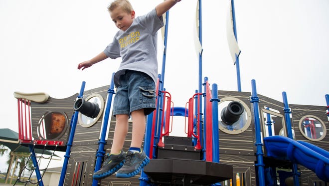Brady Knight jumps off the "plank" while playing on the Jolly Voyager Pirate Ship Playground at the Barber Street Sports Complex in December 2012. It looks like Christmas this year will have residents jumping for joy, with a 10-degree drop into the mid- to low 70s next week.