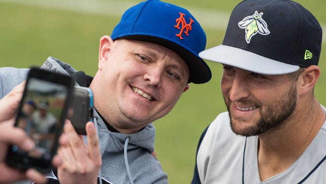 Columbia Fireflies outfielder Tim Tebow poses for a selfie with a fan during a game against the Delmarva Shorebirds at Arthur W. Perdue Stadium on Wednesday, May 10, 2017. 