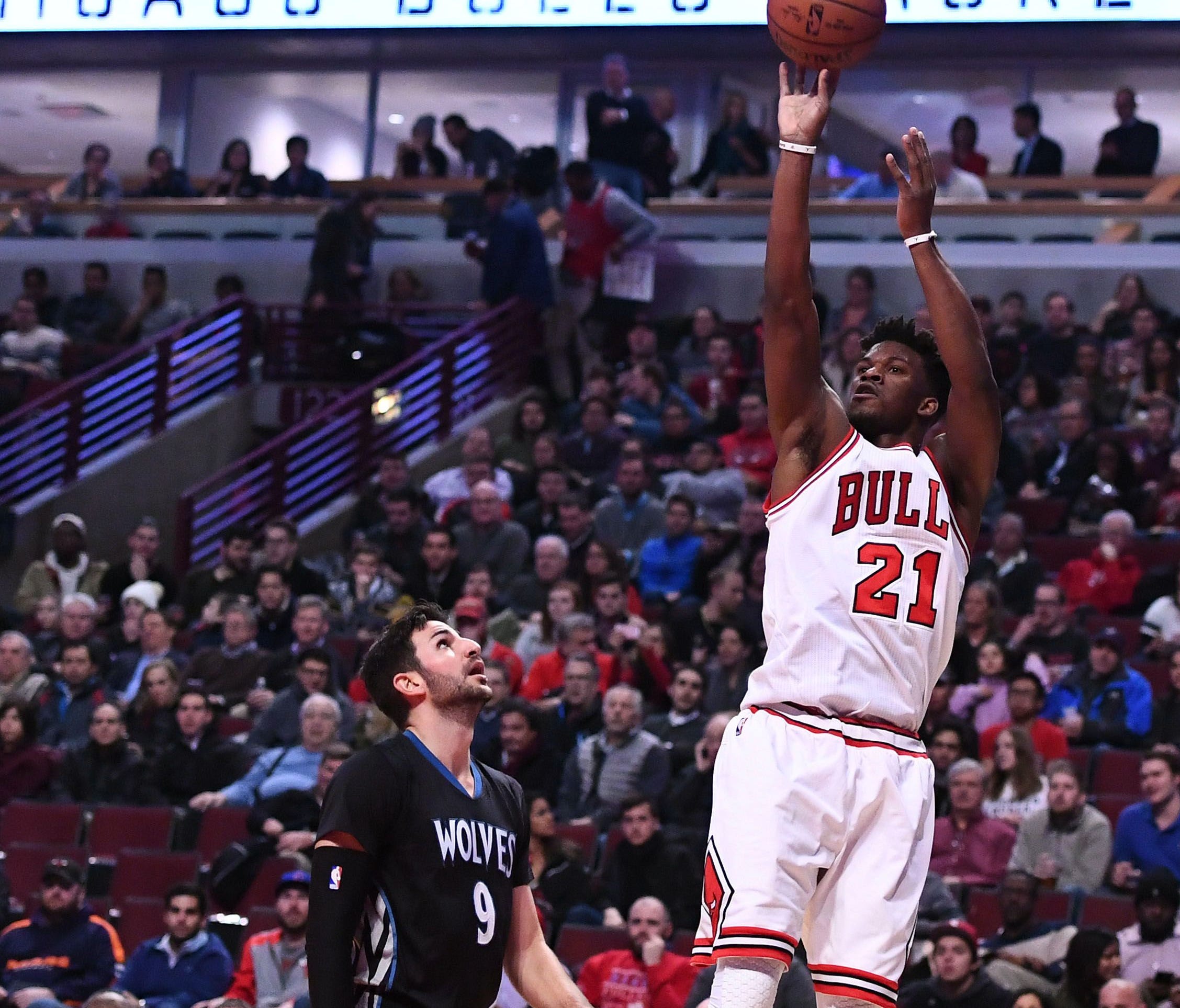 Chicago Bulls forward Jimmy Butler (21) shoots the ball against Minnesota Timberwolves guard Ricky Rubio (9) during the first half at the United Center.