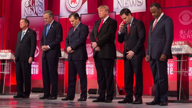 Republican presidential candidates hold a moment of silence for Associate Justice Antonin Scalia, who passed away earlier in the day. From left are:  John Kasich, Jeb Bush, Ted Cruz, Donald Trump, Marco Rubio and Ben Carson.