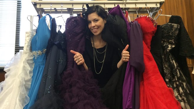 Post-Crescent Engagement Editor Sarah Riley smiles amid the dresses collected at The Post-Crescent for Operation Cinderella.