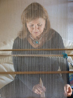 Arizona State University Professor Laura Tohe, pictured here weaving in her Mesa, Ariz., home in July, has been named the poet laureate of the Navajo Nation for 2015-1017.