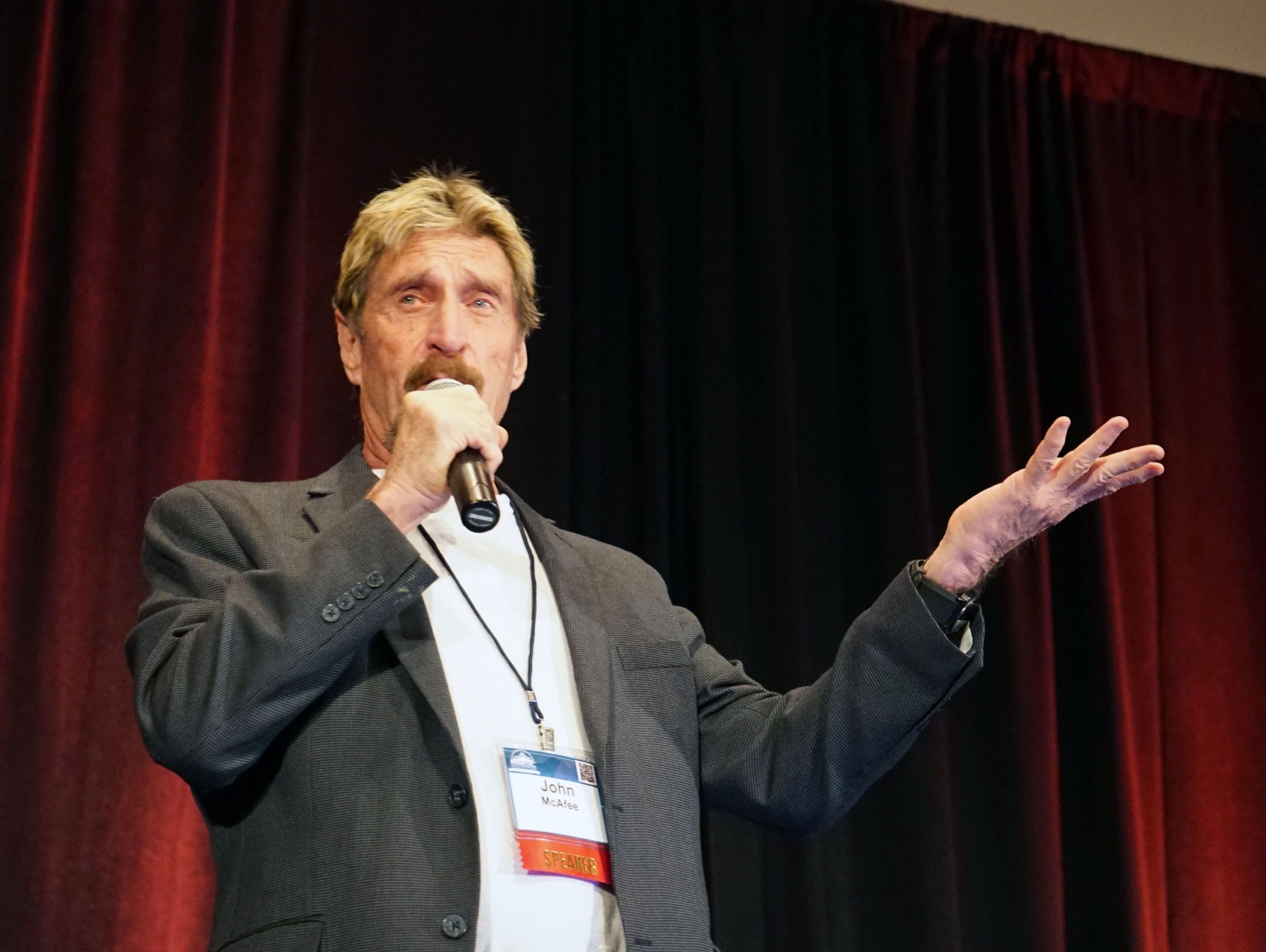 Computer security expert John McAfee discusses mobile-device flaws at an information-security conference in Denver on Wednesday.