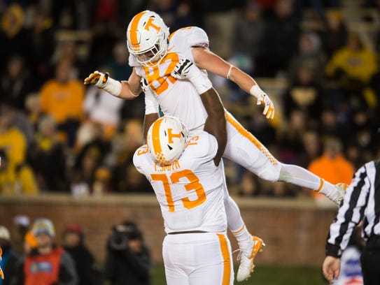 Tennessee offensive lineman Trey Smith (73) lifts tight end Ethan Wolf (82) in the air after he scored against Missouri on Nov. 11.